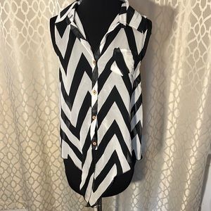 White and black women’s sleeveless top with brown buttons. Size M